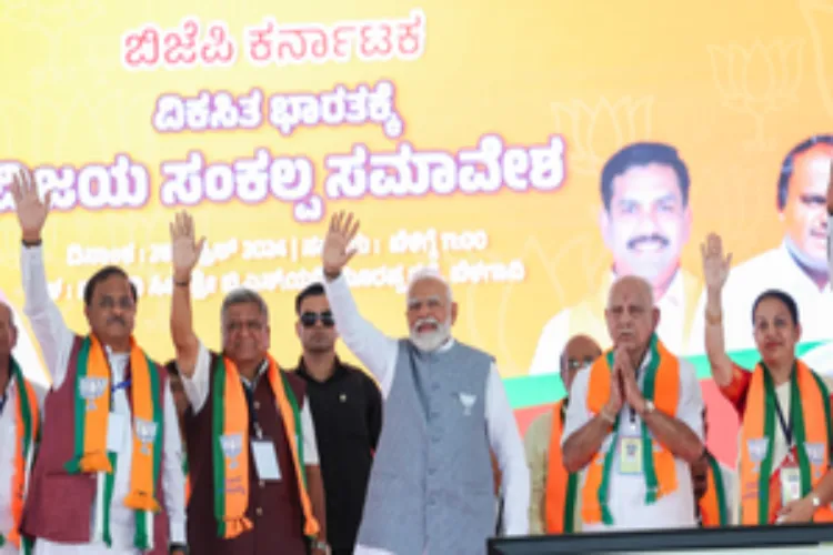 Prime Minister Narendra Modi waving to the crowds at a rally in Karnataka 