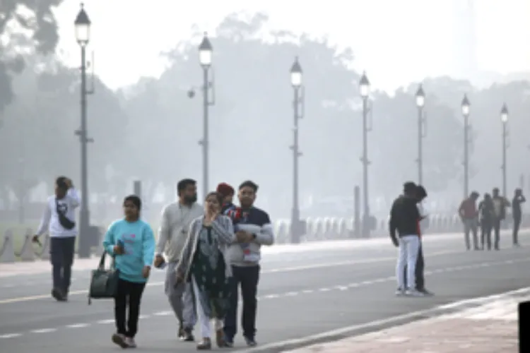 Pedestrians walking through a polluted stretch in Delhi