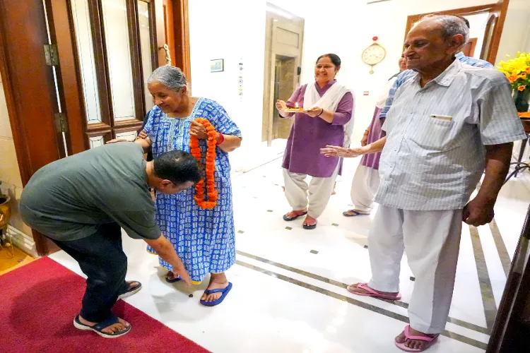 Delhi Chief Minister Arvind Kejriwal takes blessings of his mother Gita Devi after he reaches his residence, in New Delhi on Friday