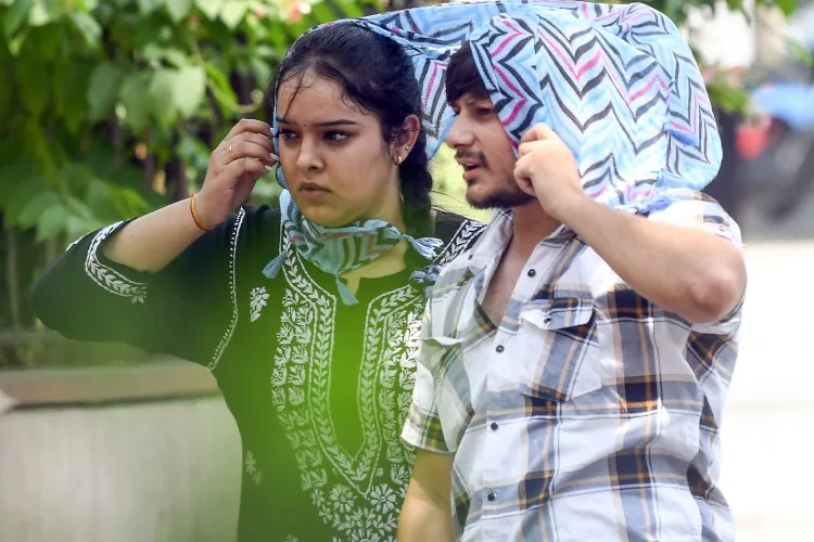 People covering their hear in scorching heat of Delhi