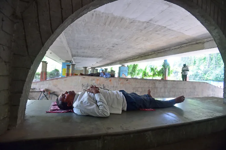 A man sleeping under a bridge in Prayagraj on Saturday afternoon to escape heat