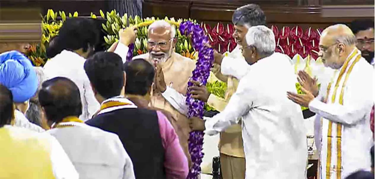 Prime Minister Narendra Modi being garlanded by NDA leaders at the meeting