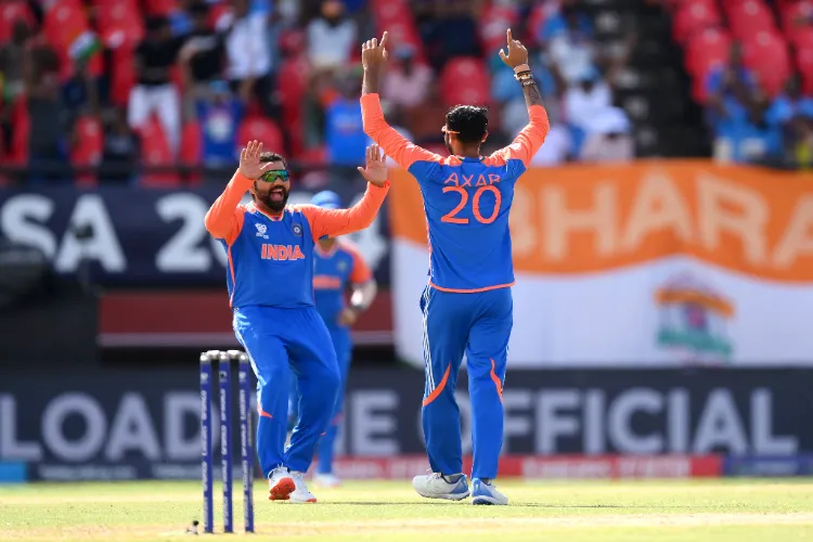 Axar Patel and Rohit Sharma celebrate the wicket of England's captain Jos Buttler