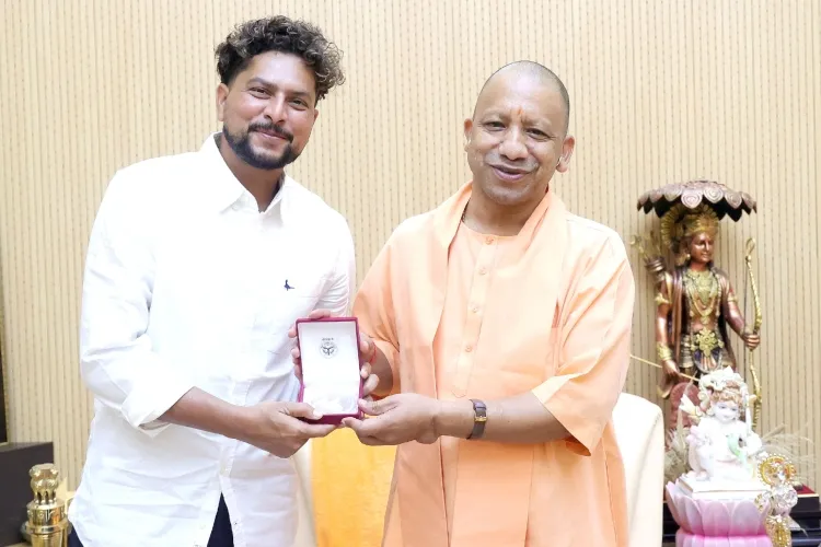 Cricketer Kuldeep Yadav showing his gold medal to UP CHief Minister Yogi Adityanath (X)