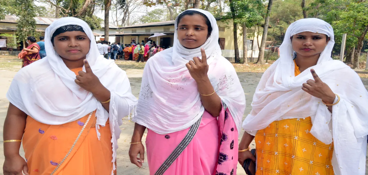 Muslim women showing their ink mark after casting their votes in Tezpur, Assam