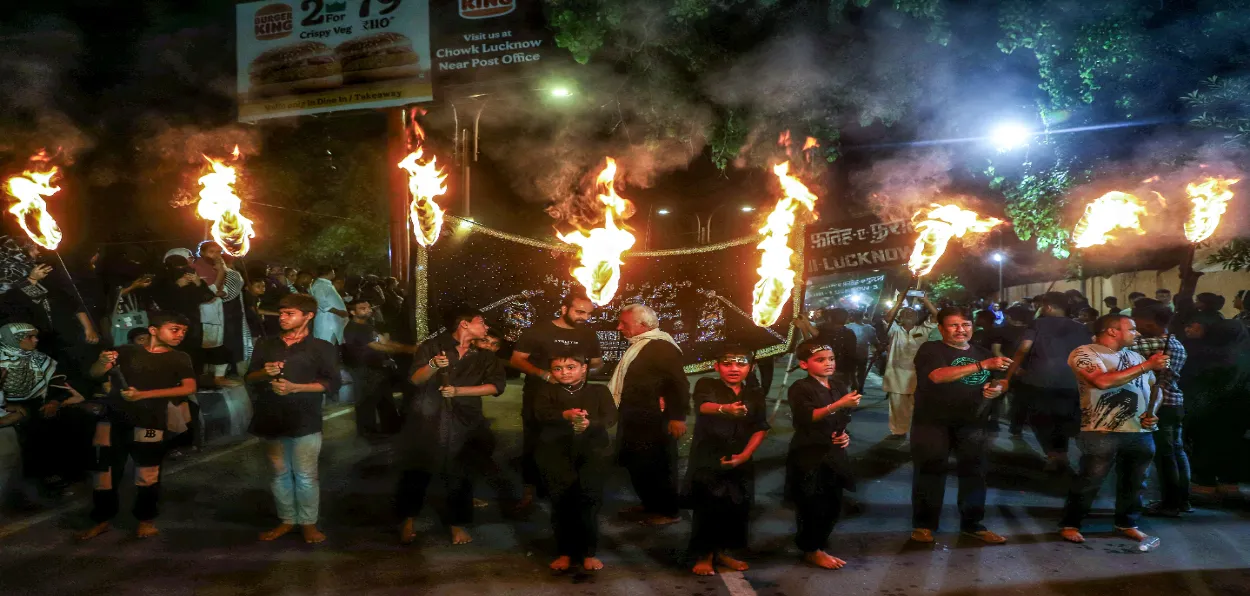 Shia Youth holding torchlights taking out a procession durIng Muharram in Lucknow