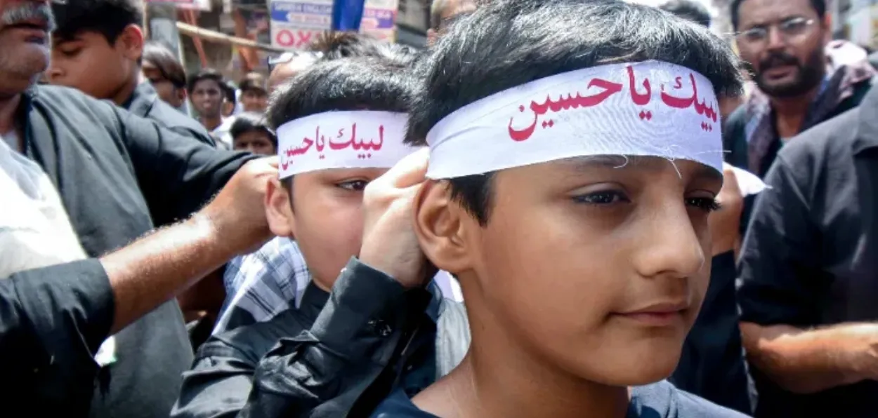 Devotees participate in the procession on the tenth day of Muharram.