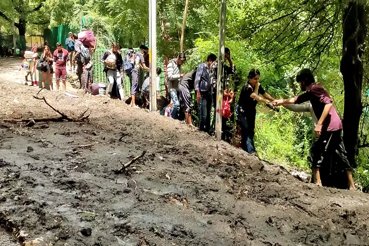 People are being rescued after two houses were destroyed at a camping site due to the cloud burst that struck Choj village of Parvati valley, in Kullu