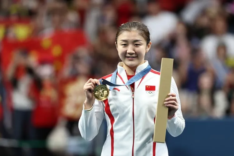 China's Chen Meng showing her gold medal in women's singles table tennis 