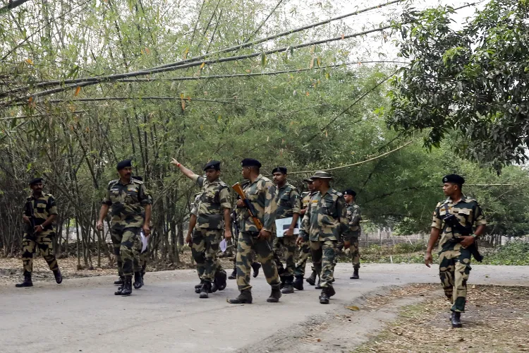  Security personnel route march at Beldanga area of Dhuliyan, Samserganj as they are deployed days after violence broke out during a protest against the Waqf (Amendment) Act 2025, in Murshidabad on Thursday.