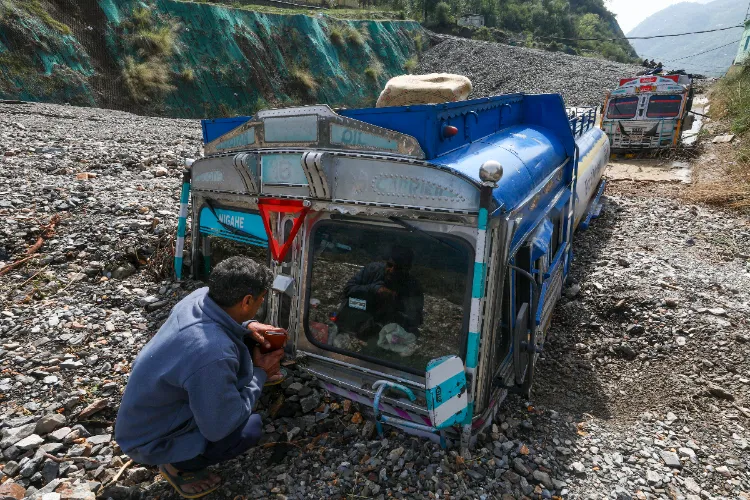 Vehicles stuck in mud after landslides and flash flood following heavy rainfall