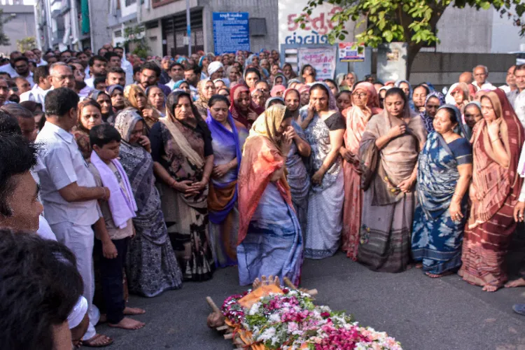 Wife of Shailesh Kalathiya, who was killed in the Pahalgam Terror Attack pays her last respects to her husband during his final rites, at Mota Varachha in Surat on Thursday.