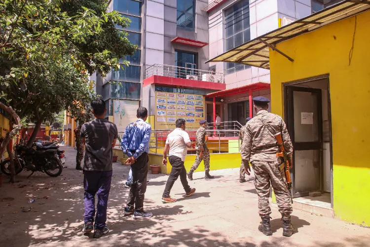 Security personnel guard as ED conducts raids at a FIITJEE centre in Noida, Thursday, April 24, 2025.