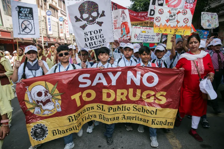 Students hold banners and placards with anti-drugs slogans.