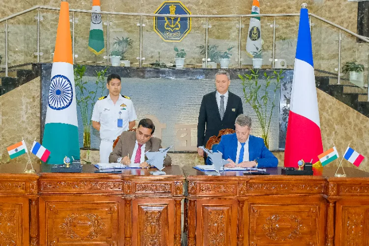 Indian and French officials sign copies of an Inter-Governmental Agreement for the procurement of 26 Rafale Aircraft (22 Single-Seater and four Twin-Seater) for the Indian Navy at Nausena Bhawan in New Delhi on Monday. 