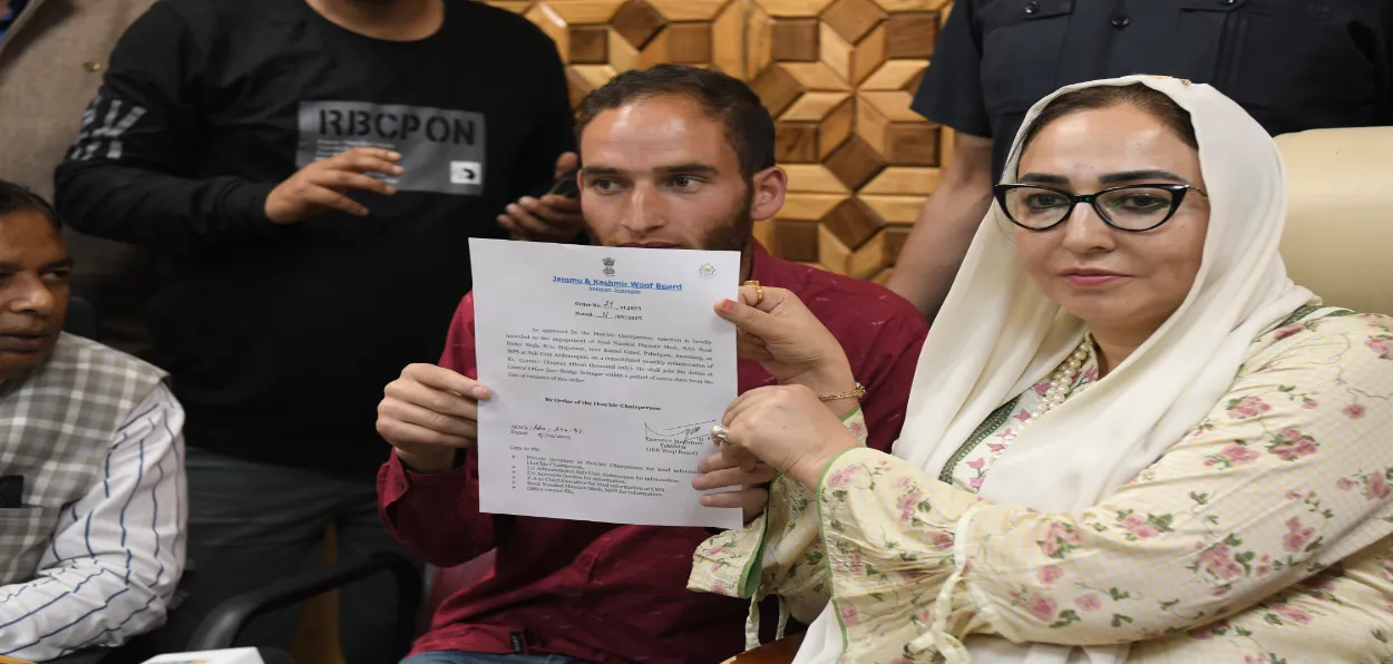 J&K Waqf Board chairperson Dr Darakhshan Andrabi giving a letter of appointment to Nazakat Ahmed (Basit Zargar)