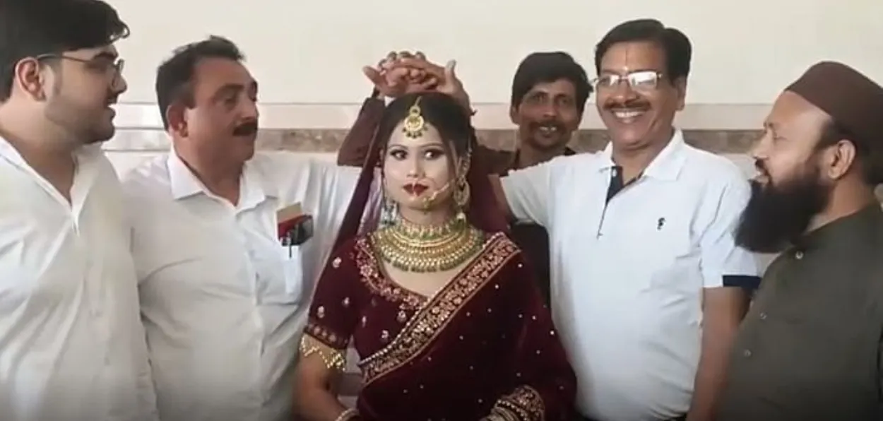 Bride Rakhi flanked by her Bade Papa, Safdar Nawaz Khan (Left of bride) and her father Gautam Kumar (right) on her wedding day