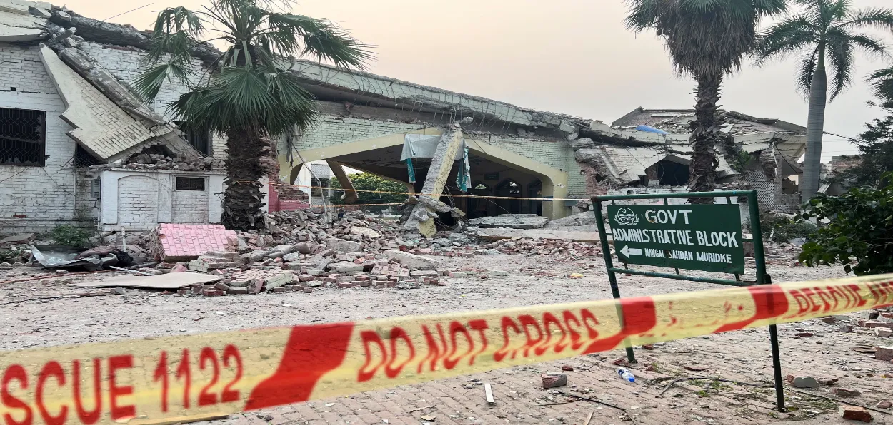 Workers clearing debris at Markaz Taiba, Muridke, the terror training and receruitment center of Lashkar-e-toiba in Pakistan