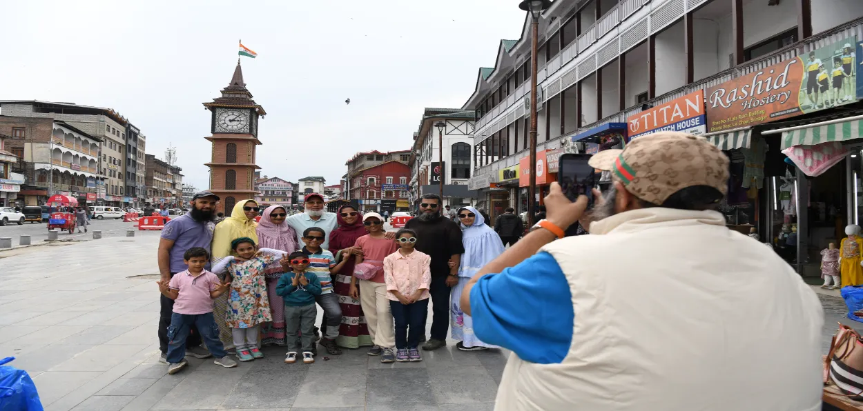 An Indian Muslim family poses in front of Ghanta Ghar in Lal Chowk, Srinagar (Pics by Basit Zargar)