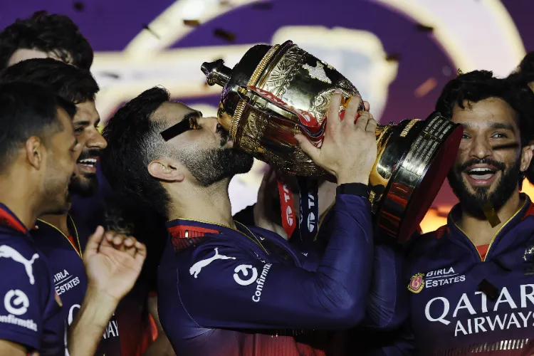 Virat Kohli kisses the IPL trophy