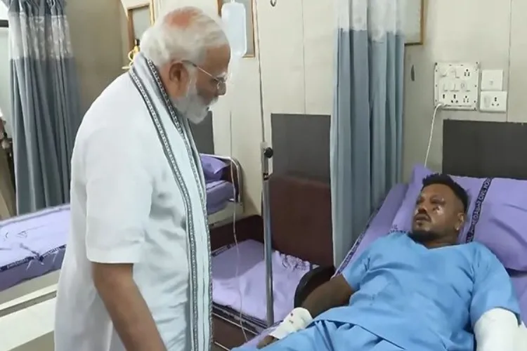 Prime Minister Narendra Modi speaking with the lone survivour of the Air India plane crash Vishwashkumar Ramesh in hospital