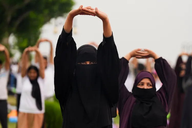 People take part in a yoga session on the occasion of International Day of Yoga, at Ghanta Ghar in Srinagar