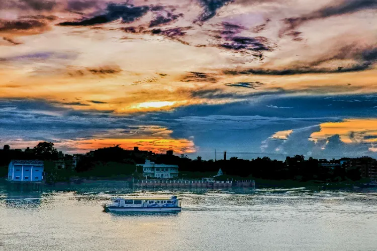 A view of a colourful sky over the Ganga River after the pre - monsoon rain, in Kolkata