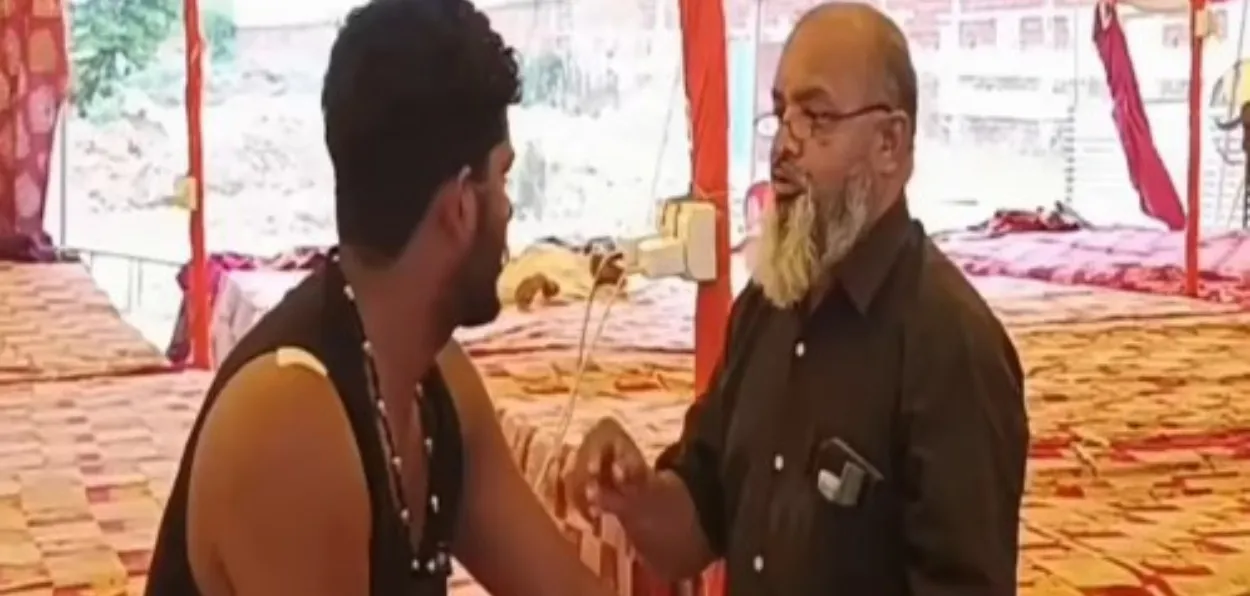 Dr babu Khan tending to a Kanwar pilgrim at his camp in Bhagpath