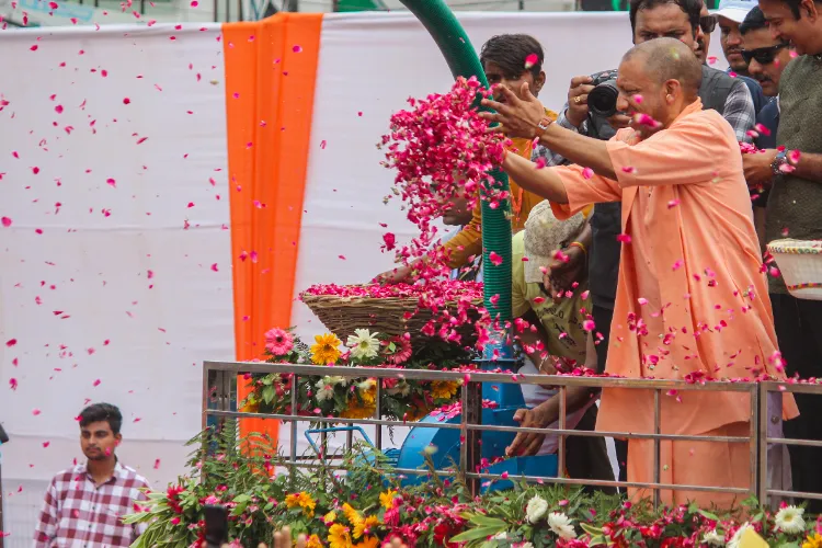 UP CM Yogi Adityanath showers flower petals on 'Kanwariyas' during their pilgrimage in the holy month of 'Shravan'