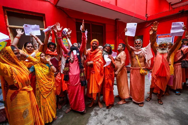 Jammu: 'Sadhus' raise slogans as they wait for their registration for the annual Amarnath Yatra at Ram Mandir base camp