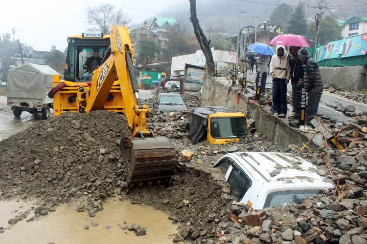 Cranes extricating vehicles buried in mudslide in Himachal