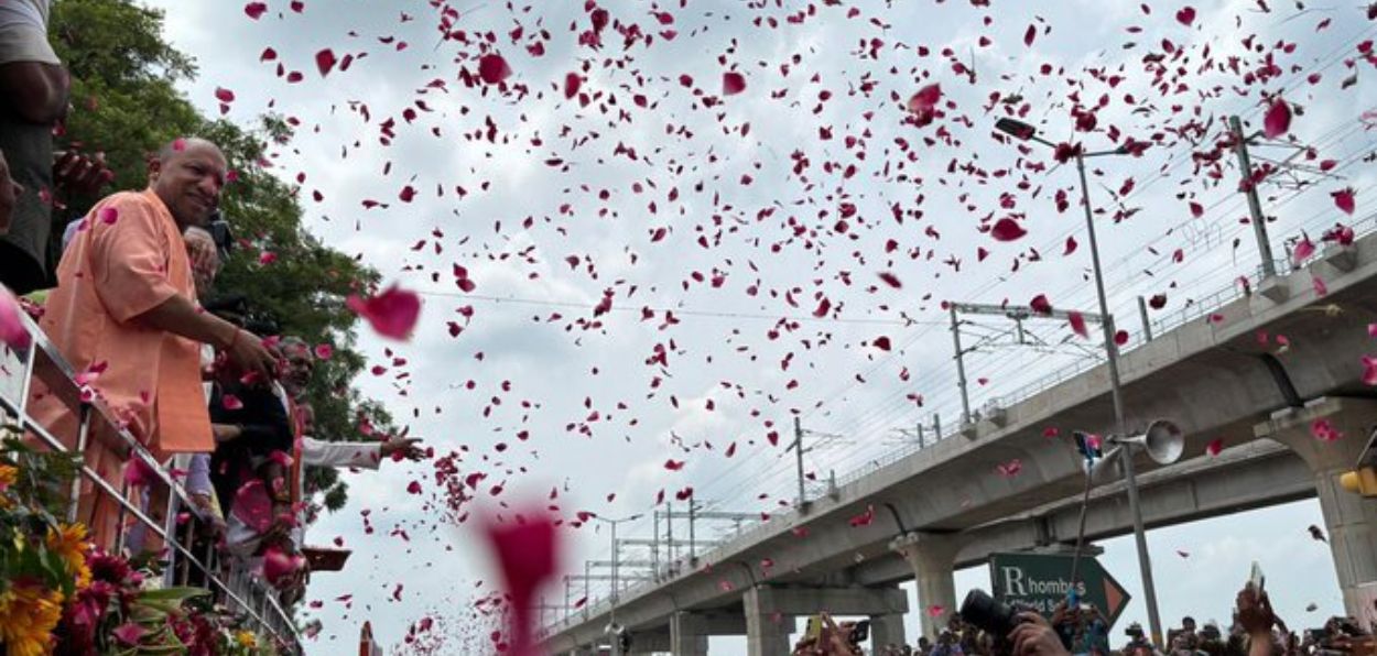 Uttar Pradesh Chief Minister Yogi Adityanath showering petals on pilgrims