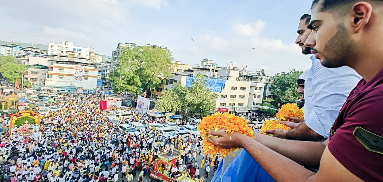 Muslim men showering petals on devotees during Navratri festival in Thane, Mumbai 