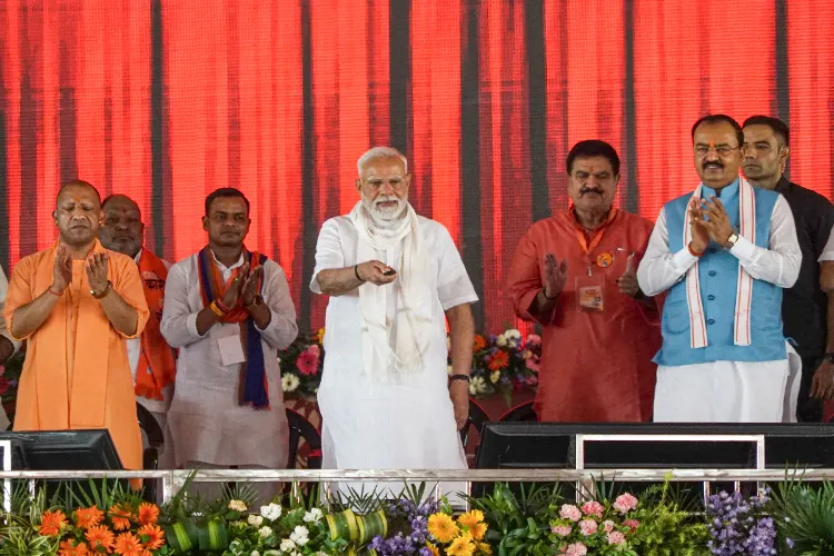 Prime Minister Narendra Modi, Uttar Pradesh Chief Minister Yogi Adityanath and others during the inauguration and foundation stone laying of various development projects at a public meeting, in Varanasi