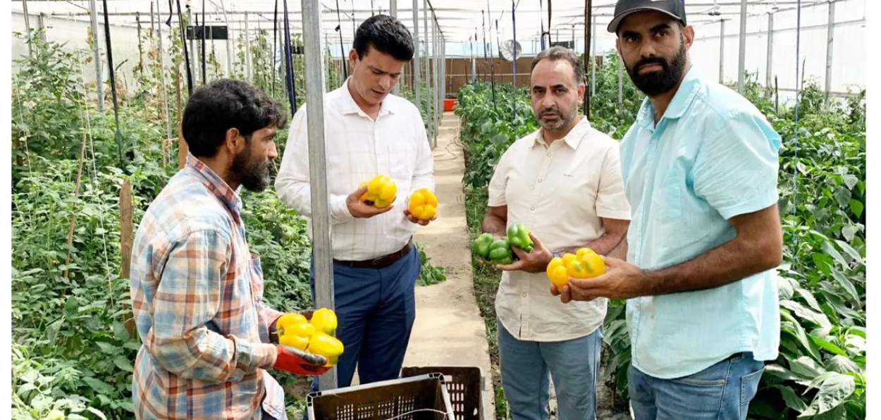 Asif Ali Bhat (second from left) at his farm with officials