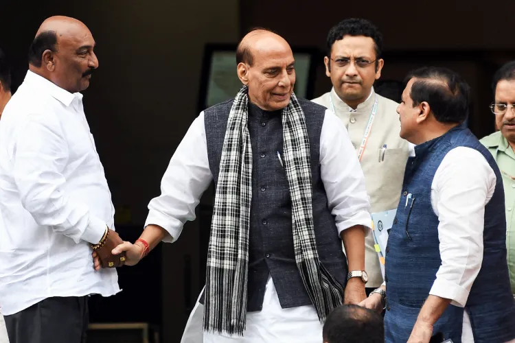 Defence Minister Rajnath Singh and AAP MP Sanjay Singh exchanging pleasantries in Parliament
