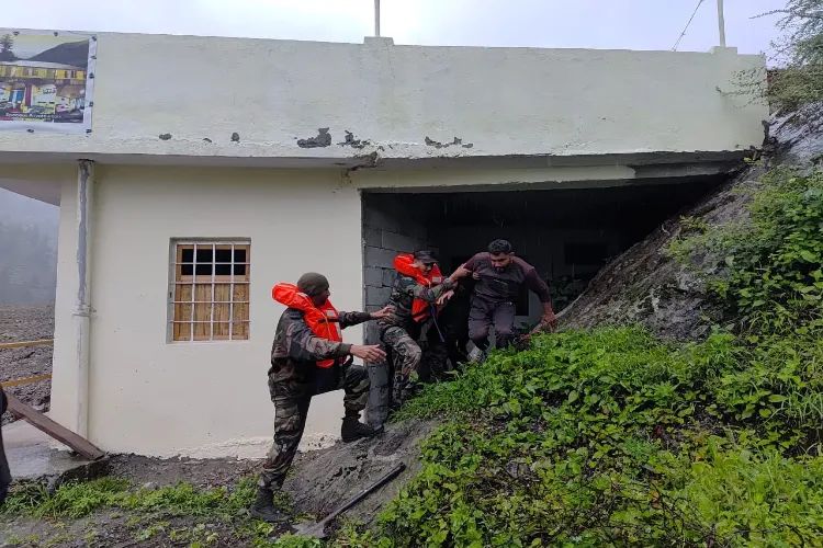 Army men rescuing a man in Uttarkashi