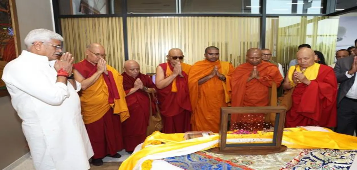 Monks and Minister for culture Gajendra Singh Shekhawat praying before the relics of Lord Buddha