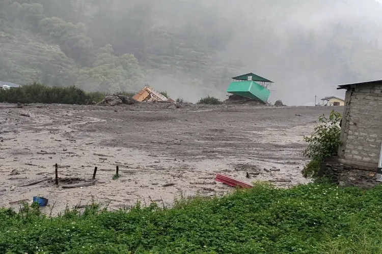 Houses in village Dharali under debris left by flash floods