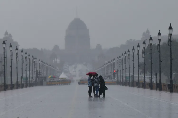 People enjoying themselves in the rain at Kartavya Path