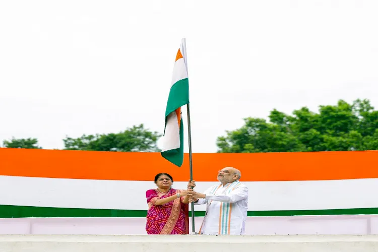 Union Home Minister Amit Shah along with his wife Sonal Shah, hoists the national flag at their residence (file)