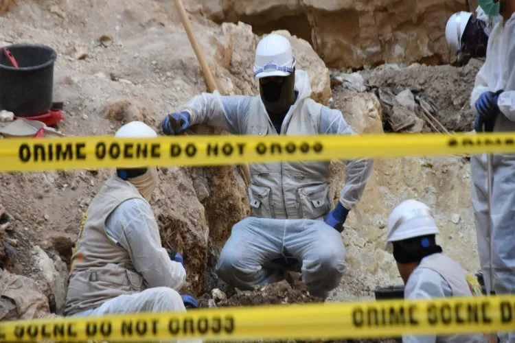 Workers at the site of suspected Mass grave