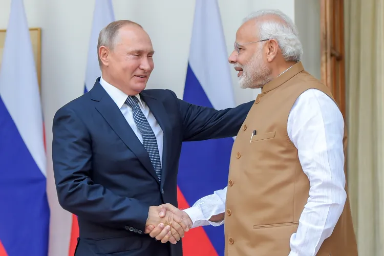 Prime Minister Narendra Modi shakes hands with Russian President Vladimir Putin before their meeting at Hyderabad House, in New Delhi