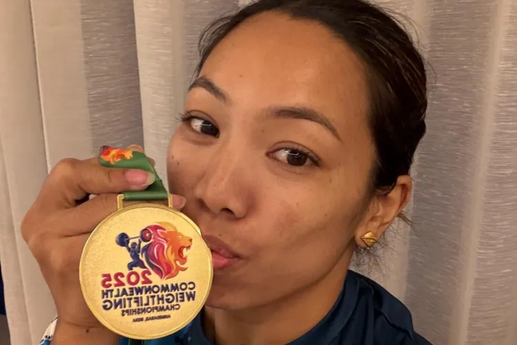  Mirabai Chanu kissing her Gold Medal at  at the Commonwealth Weightlifting Championships in Ahmedabad