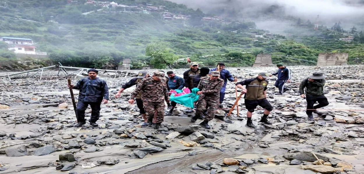 Security forces rushing a man rescued from the cloudburst in Dharali for medical treatment
