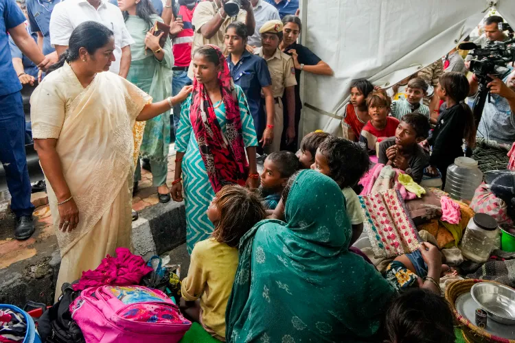 Delhi CM Rekha Gupta interacts with people during her visit to the Yamuna floodplain near Geeta Colony