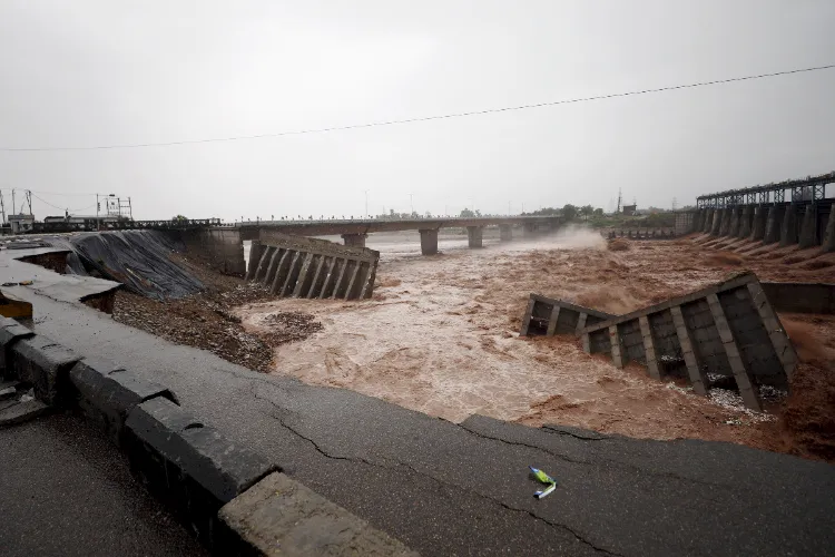 The remaining part of the4th Tawi bridge connecting the city of Jammu collapses