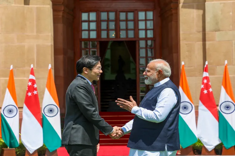 Prime Minister Narendra Modi shakes hands with Singapore's Prime Minister Lawrence Wongat, at Hyderabad House, in New Delhi