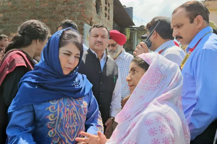 Mehbooba Mufti assuring support to a local in the flood hit area of Jammu