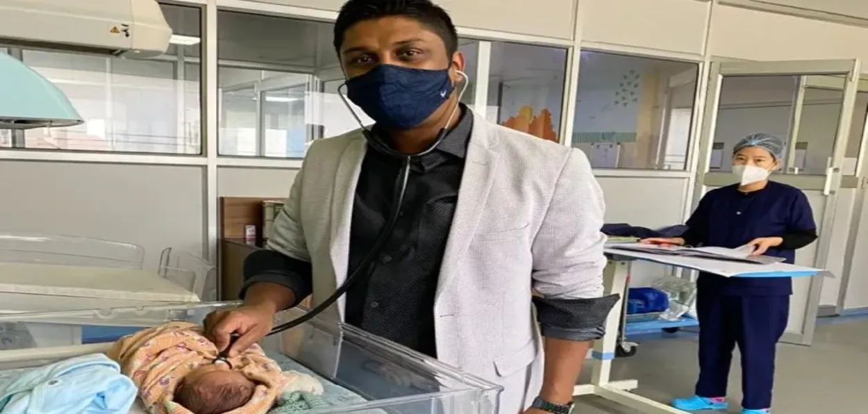 Dr Yasin Ali with the infant he treated